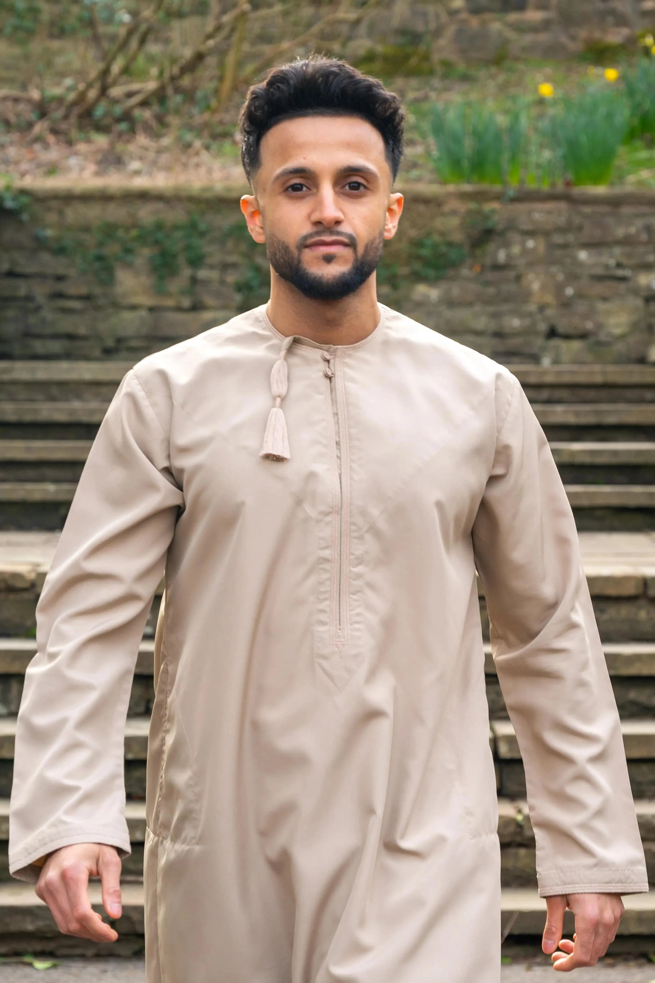 Outdoor shot in natural light of our Omani Thobe / jubba in Sand / Cream Beige colour
