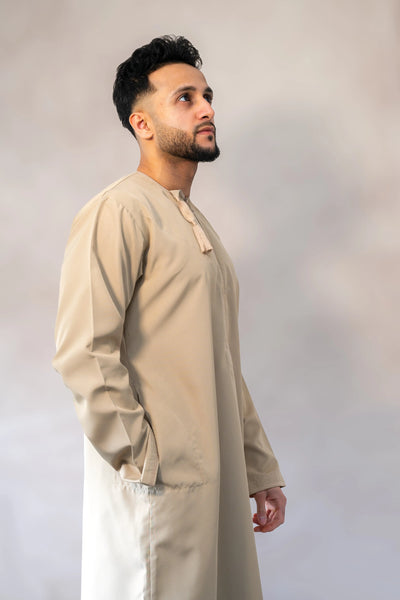 Men’s premium traditional Omani sand / cream-colored thobe / jubba with relaxed fit and elegant stitching.