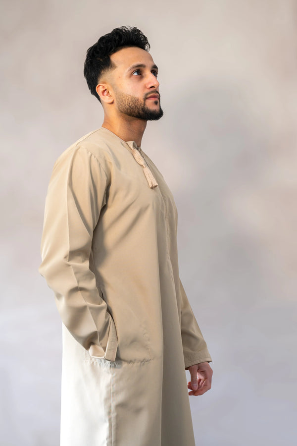 Men’s premium traditional Omani sand / cream-colored thobe / jubba with relaxed fit and elegant stitching.