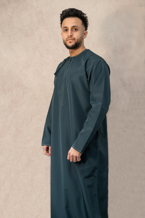 Men’s premium traditional Omani teal blue thobe / jubba made with water-repellent, high-quality fabric and detailed high thread count embroidery